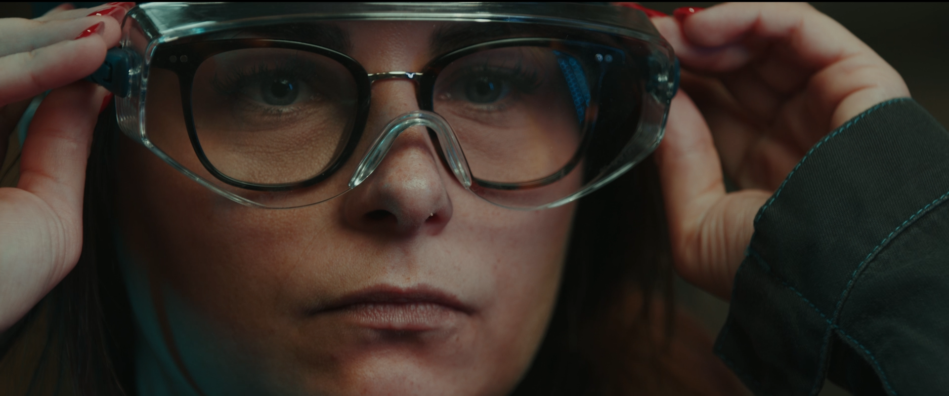 Photo of an ACC employee adjusting safety glasses, from the 4 years anniversary movie