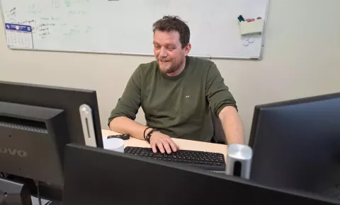 Photo of Dominique Bougard, Gigafactory employee, at his workstation.